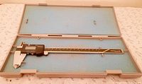 Caliper inside open Mitutoyo case, showing foam insert