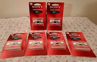 Six sealed Sony MC-90 microcassettes displayed front