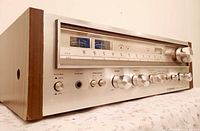 Front angled view showing controls, tuner scale and wood-sided cabinet
