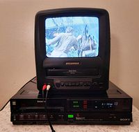 Sony SL-HF300 VCR with television demonstrating playback