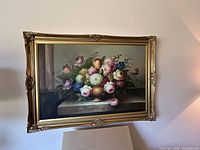 Full view of framed floral painting on wall