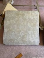 Light grey vinyl surface of first table