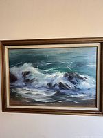 Full view of framed seascape painting on wall
