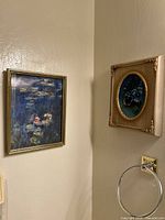 Both framed artworks hanging side by side