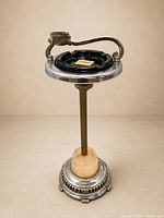 Full view of floor-standing ashtray showing top, stem, illuminated base