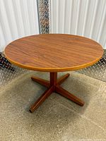 Full view of round side table showing top, pedestal and legs