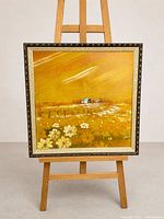 Full view of framed oil painting on easel