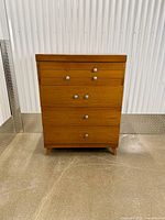 Front view showing all four drawers and metal knobs
