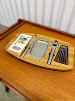 Overall view of wooden tray holding utensils and drip tray
