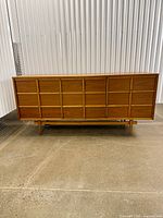 Front view showing 9-drawer grid layout and legs