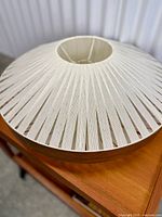 Top angled view showing woven shade pattern and central opening