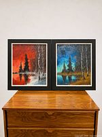 Pair of framed oil landscape paintings on dresser