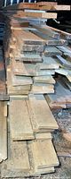 Stack of rough cut ash boards viewed from side