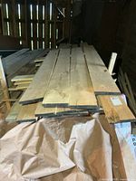 Stack of rough-cut lumber boards showing width and rough edges