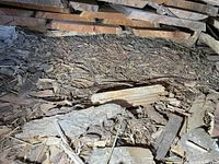 Stack of rough sawn cherry boards over debris