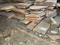 Stack of rough-sawn cherry boards with live edges and bark