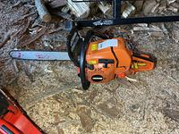 Left side view of Echo CS-590 chainsaw showing bar, chain and casing