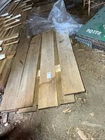 Stack of rough cut oak boards on floor