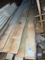 Stack of rough-cut pine and spruce boards showing saw marks and live edges