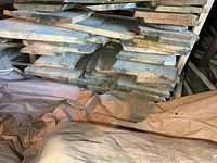 Stacked rough-cut pine boards in barn