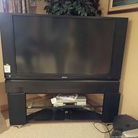 Front view of 50-inch Hitachi LCD TV on base stand