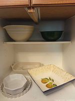 Overview of all baking and serveware pieces inside cupboard