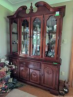 Full view of two-piece china cabinet showing upper glass doors, lower storage