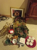 Overview of lot showing wreaths, sleigh, mugs, napkins, tin, tray with candles