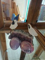 Front view of amethyst bird sculpture with two marble eggs