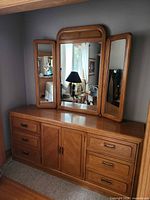 Full view of dresser with tri-panel mirror mounted on top