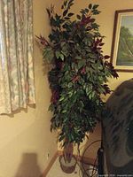 Full view of potted artificial ficus tree in room corner