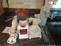Group shot showing immersion blender, fry cutter, hand mixer with attachments, mandoline