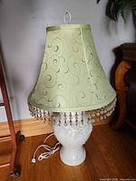 Full lamp with shade showing design and fringe