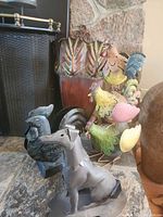 Group view: greyhound figure, rooster tealight, three hens, wall planter behind