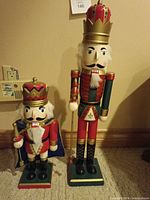 Front view of both nutcrackers showing overall condition and size difference