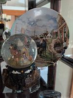 Plate and snow globe displayed together
