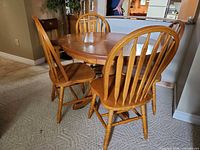 Dining set showing table and three chairs