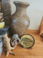 Large glazed clay vase, zebra plate on stand, wood carving and clay figure