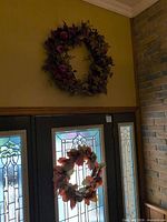 Both wreaths hanging, showing relative sizes and overall appearance