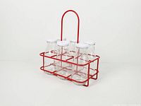 front angle view of bottles inside red wire crate