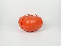 Closed orange clamshell carry container side view