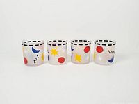 Four frosted glass tumblers front view showing full pattern and height