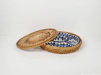 lidded rattan tray with porcelain bowls inside