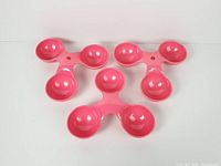 Three pink melamine tri-bowl dishes top view