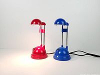 Red and blue IKEA Espressivo lamps lit and unlit position