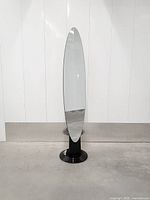 Full front view of mirror showing oval glass and pedestal