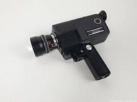 Full left-side view showing lens, body, grip folded out