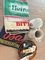Three bar towels, two steins, ashtray with accessories