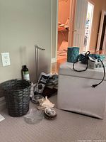 Group shot showing ottoman, basket, holder, candle, towels and accessories