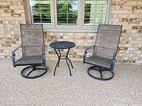 Two sling patio chairs and round mesh bistro table on patio
